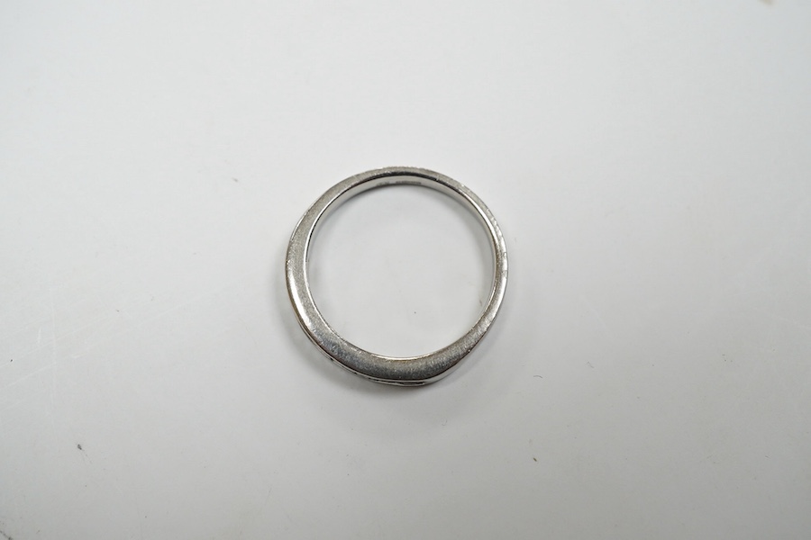 A modern platinum and fifteen stone channel set baguette cut diamond set half hoop ring, size J, gross weight 3.4 grams. Condition - fair to good